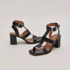 Heeled sandals in black leather